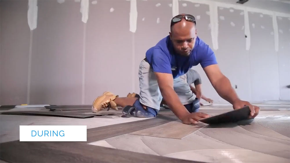 Installation of glue down luxury vinyl plank flooring by flooring installer