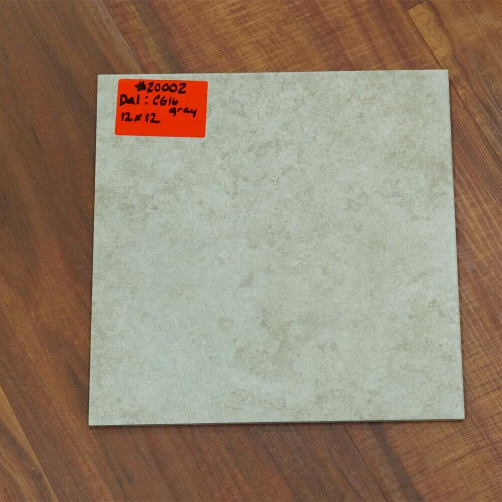 Closeup of white tile on top of hardwood floor