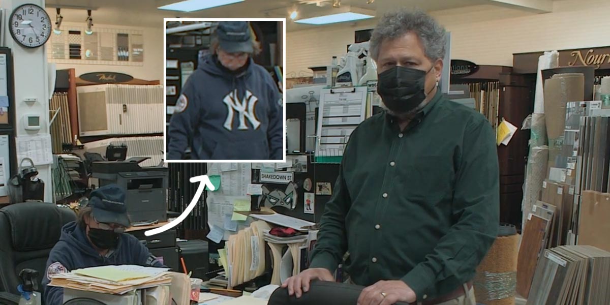 Ken Fain stands next to Greg Canale's desk at Island Carpet