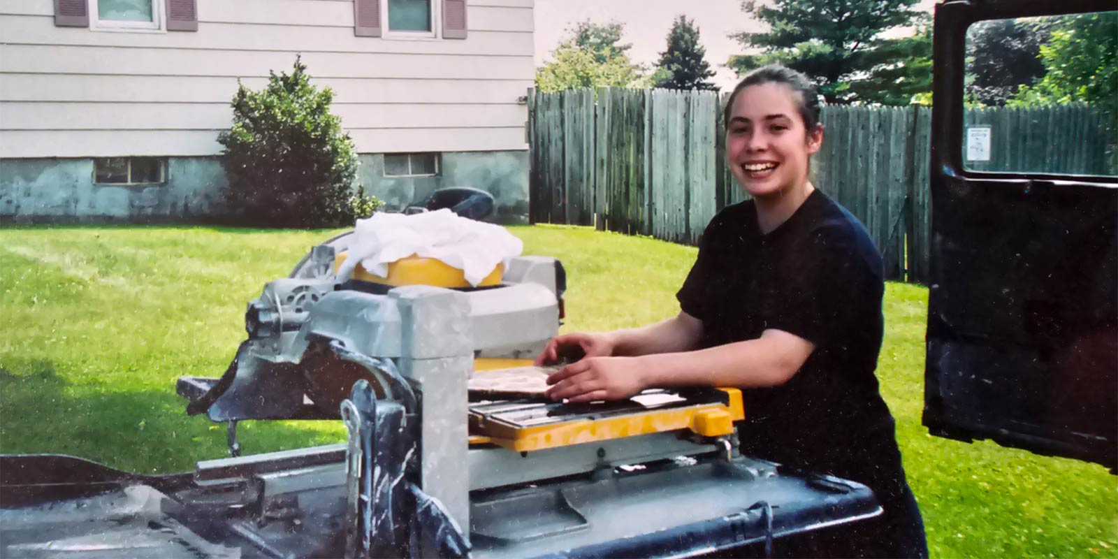 Photo from 1998 of tile installer Kasey Harkin cutting tile